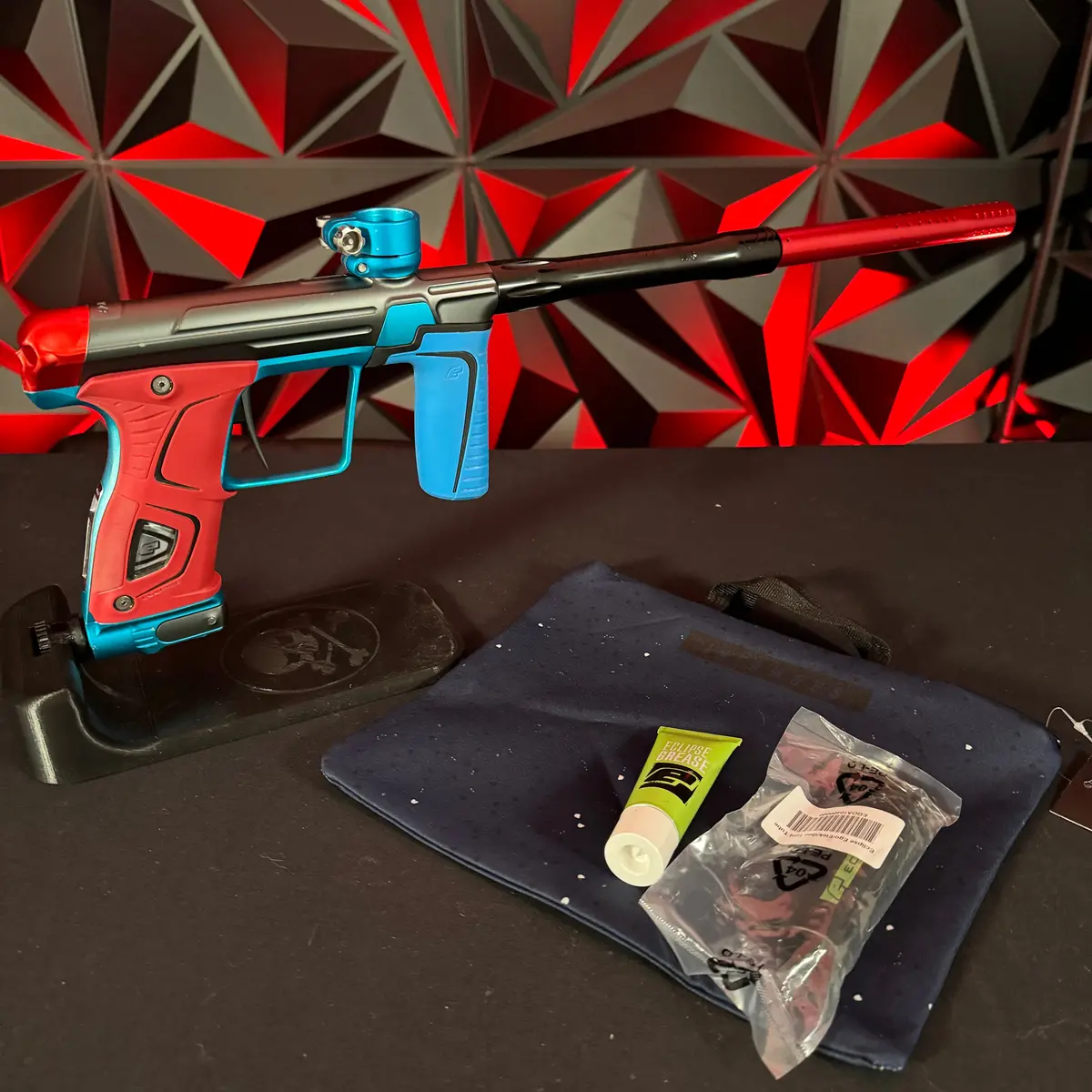 Used Gtek 170R Paintball Gun - Grey/Teal W/ Red & Blue Grips, Red Infamous Back Cap, & Dye Ul-S Barrel 1
