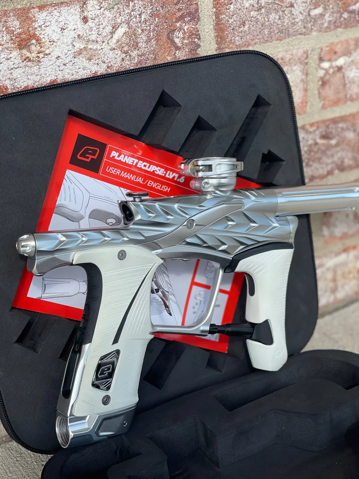 Used Planet Eclipse/Hk Army Fossil Lv1.6 Xv Paintball Gun - Pure (Silver) W/ White And Black Grips, Infamous Silencio Barrel Tip, And Infamous Deuce Trigger 1
